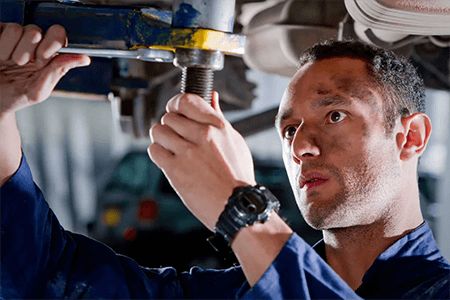 Mechanic working under a vehicle lift